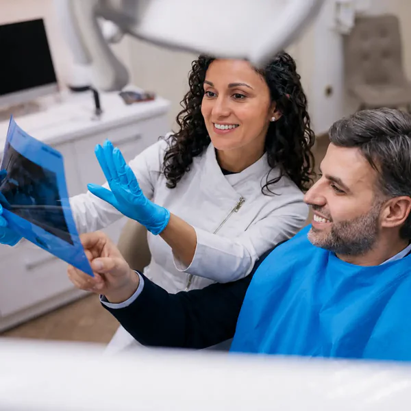 Dentist and patient reviewing dental X-rays together